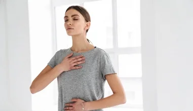 Woman breathing consciously with her hand on her chest – acute measures for PNES
