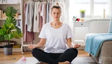 Woman practicing yoga cross-legged – preventive measures for PNES